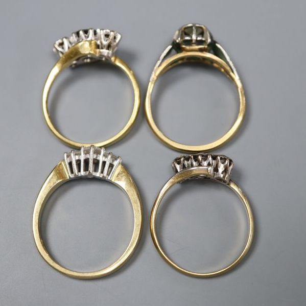 Four assorted 18ct and gem set rings,